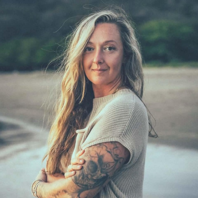 Gracie, founder of Carnosine Queen, outdoors with arms crossed